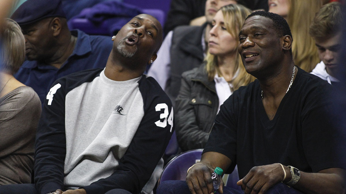 Seattle Supersonics former guard Gary Payton and former forward Shawn Kemp react to a play during the the second half of a game in which their sons Oregon State Beavers guard Gary Payton II (1) and Washington Huskies forward Shawn Kemp, Jr. (40) play at Alaska Airlines Arena.