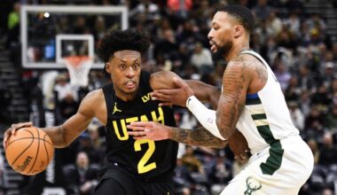 Collin Sexton #2 of the Utah Jazz drives against Damian Lillard #0 of the Milwaukee Bucks...