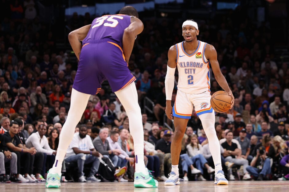 Shai Gilgeous-Alexander being defended by former OKC legend Kevin Durant