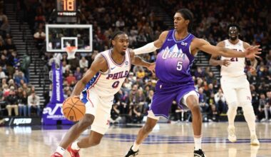 Tyrese Maxey #0 of the Philadelphia 76ers drives into Cody Williams #5 of the Utah Jazz