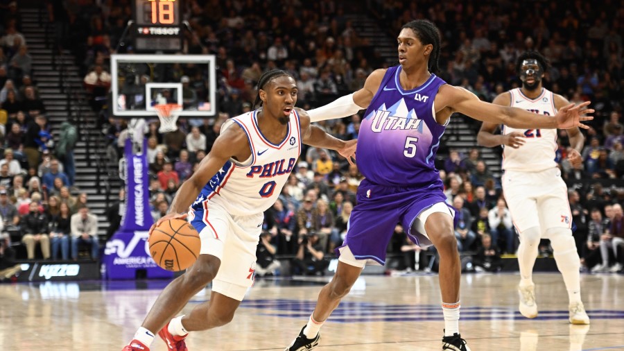 Tyrese Maxey #0 of the Philadelphia 76ers drives into Cody Williams #5 of the Utah Jazz