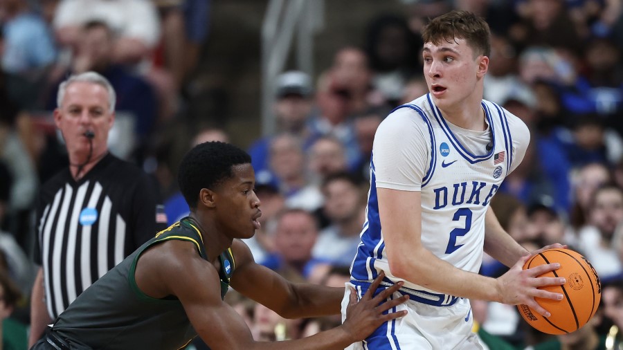 Cooper Flagg #2 of the Duke Blue Devils is defended by VJ Edgecombe #7 of the Baylor Bears