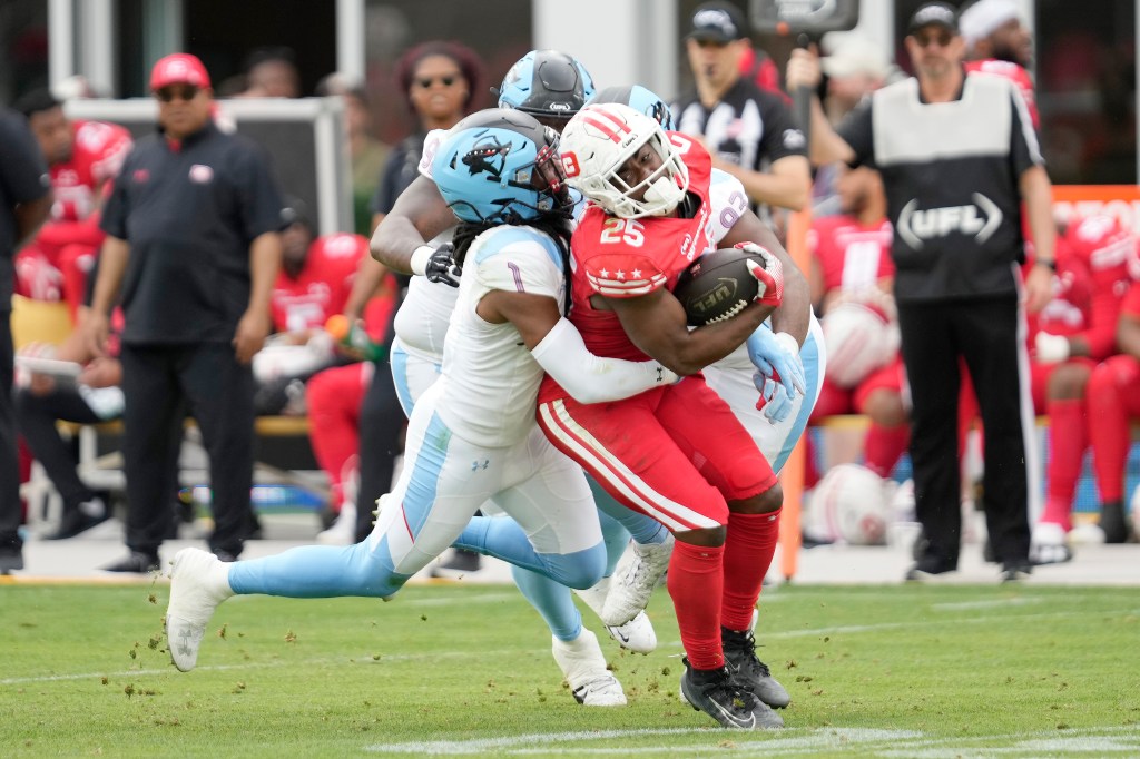 Deon Jackson of the DC Defenders is tackled by Joe Powell of the Arlington Renegades during the second half at Audi Field on May 18, 2025 in Washington, DC.