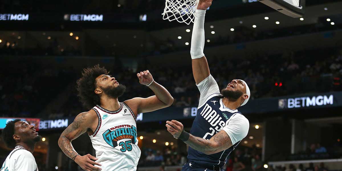 Dallas Mavericks center Daniel Gafford (21) dunks as Memphis Grizzlies forward Marvin Bagley III (35) defends during the first quarter at FedExForum.
