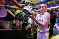 Dallas Wings guard Paige Bueckers (5) signs autographs after an WNBA preseason basketball...