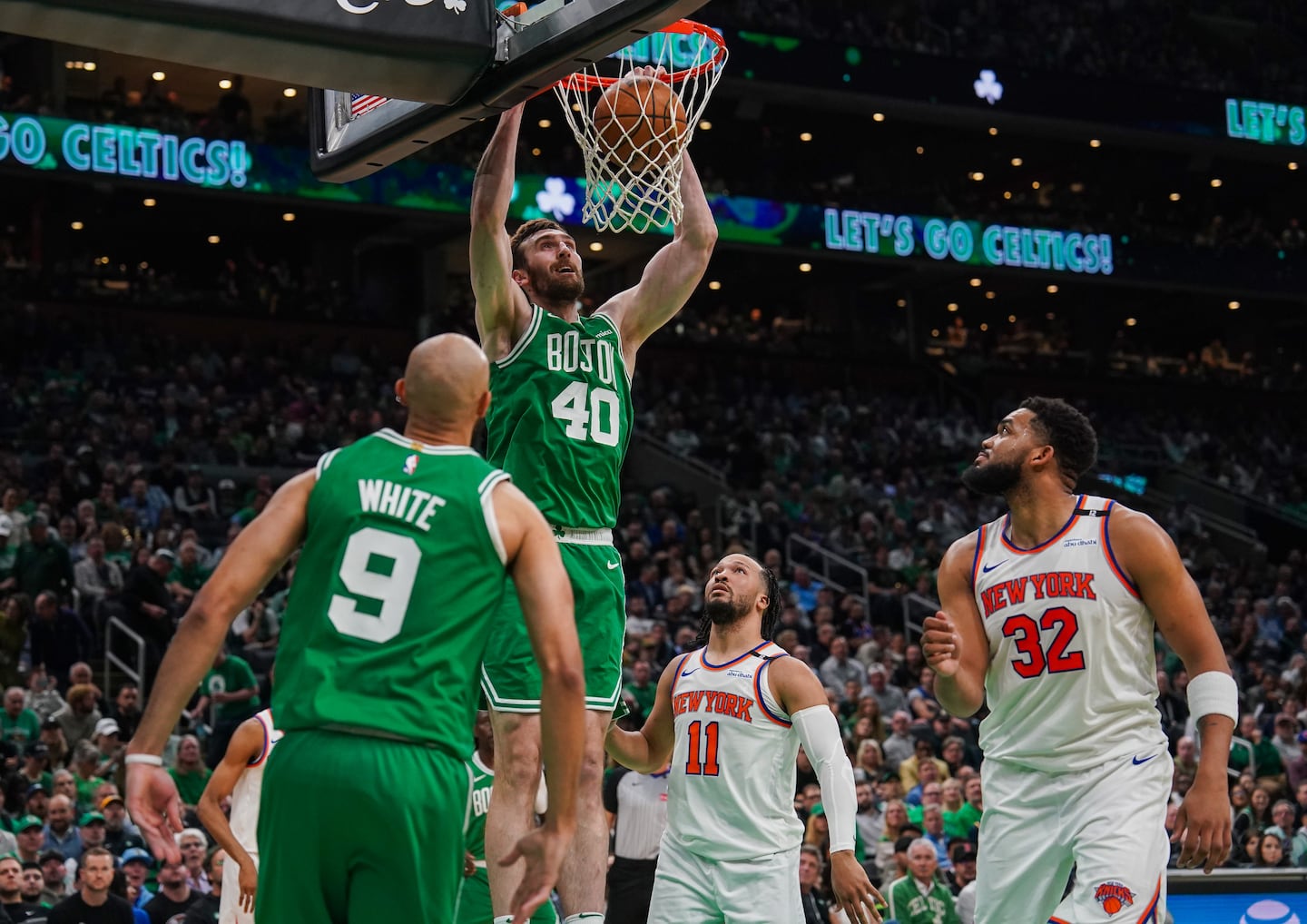 Boston Celtics center Luke Kornet (40) dunks off a pass from Boston Celtics guard Derrick White (9) during the second quarter.