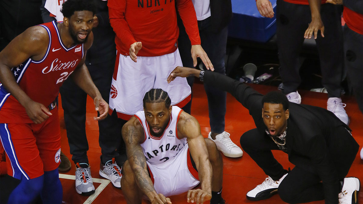 Philadelphia 76ers center Joel Embiid (21) and Toronto Raptors forward Kawhi Leonard (2) wait for the game winning basket by Leonard to drop in during game seven of the second round of the 2019 NBA Playoffs at Scotiabank Arena. Toronto defeated Philadelphia. Mandatory