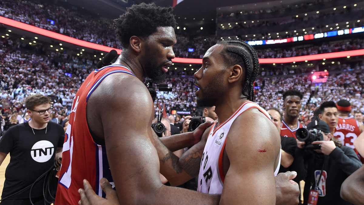Toronto Raptors forward Kawhi Leonard (right) is embraced by Philadelphia 76ers center Joel Embiid (21) at the end of game seven of the second round of the 2019 NBA Playoffs at Scotiabank Arena.