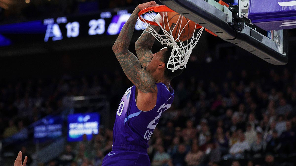 Utah Jazz forward John Collins (20) grabs the ball out of the air and dunks it against the Indiana Pacers during the first quarter at Delta Center