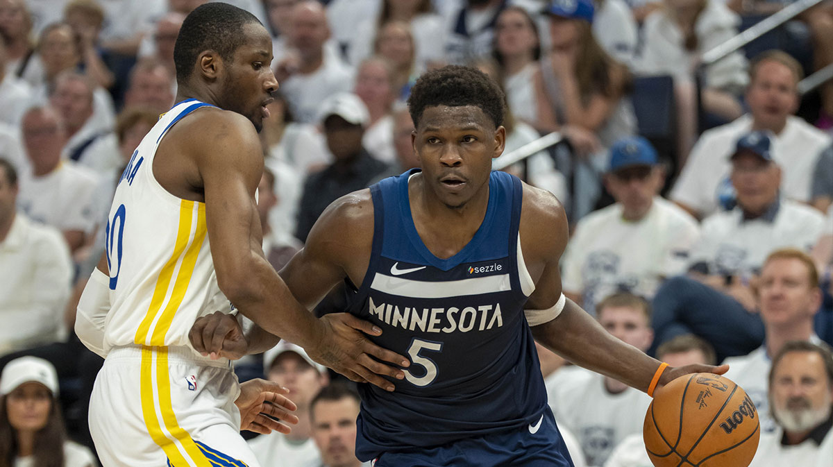 Minnesota Timberwolves guard Anthony Edwards (5) drives to the basket past Golden State Warriors forward Jonathan Kuminga (00) in the first half during game five of the second round for the 2025 NBA Playoffs at Target Center.
