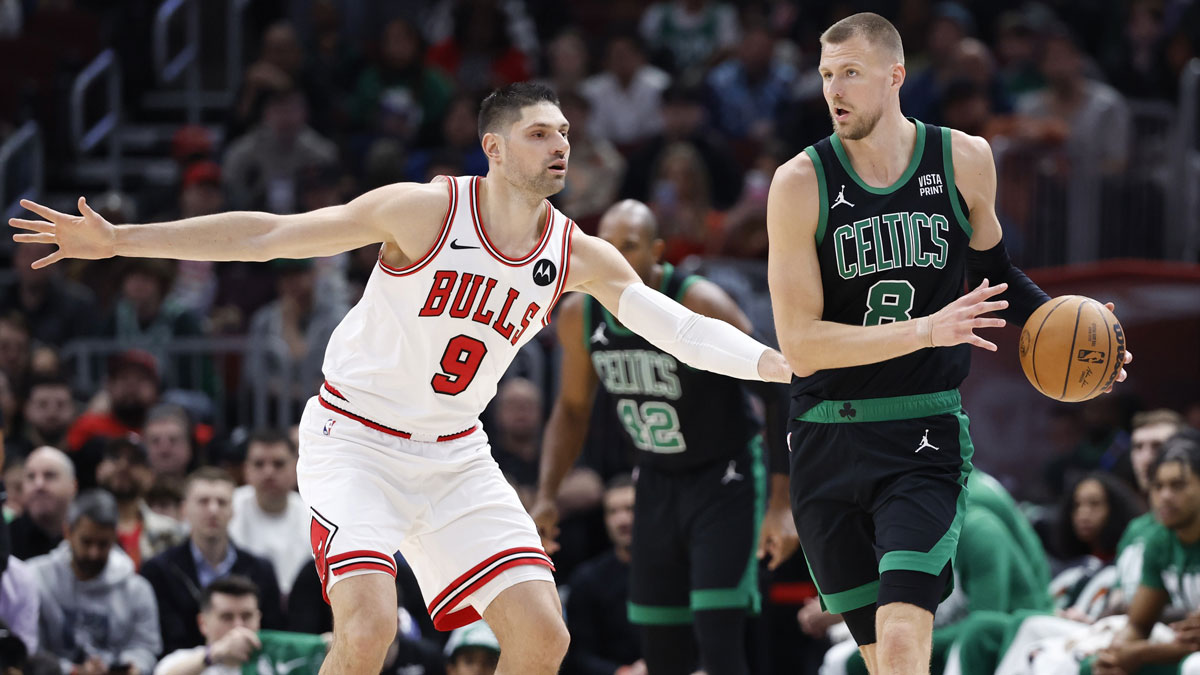 Boston Celtics center Kristaps Porzingis (8) looks to pass the ball against Chicago Bulls center Nikola Vucevic (9) during the first half at United Center. 