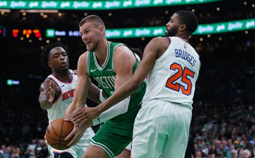 New York Knicks forward Mikal Bridges (25) and forward OG Anunoby (8) defend against Boston Celtics center Kristaps Porzingis (8) in the second half during game two of the second round for the 2025 NBA Playoffs at TD Garden. 