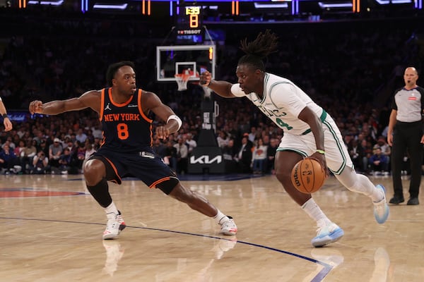 Boston Celtics' Jrue Holiday, right, drives to the basket against New York Knicks' OG Anunoby, left, during the second half of an NBA basketball game, Tuesday, April 8, 2025, in New York. (AP Photo/Pamela Smith)