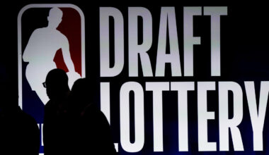 People walk by a sign during the NBA Draft Lottery...