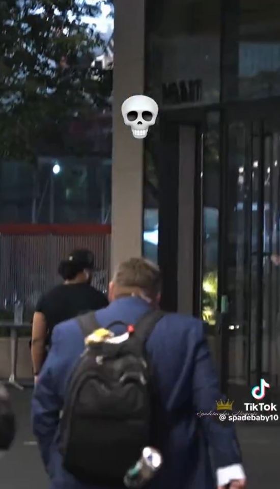 Person with backpack walking away from a building with a skull graphic superimposed.