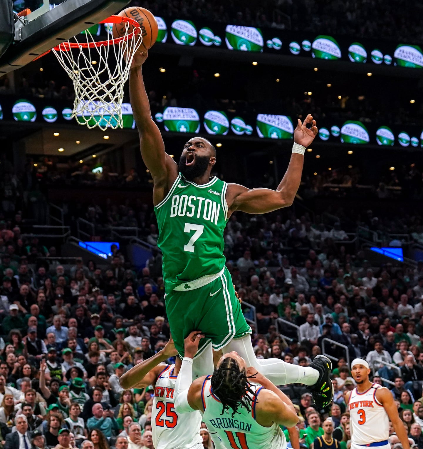 Boston Celtics guard Jaylen Brown (7) drives to the rim against New York Knicks guard Jalen Brunson during the first quarter. Brown was called for an offensive foul.