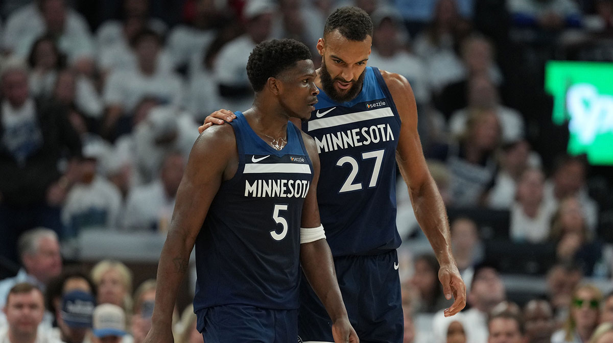 Minnesota Timberwolves guard Anthony Edwards (5) and center Rudy Gobert (27) talk against the Oklahoma City Thunder in the first half during game four of the western conference finals for the 2025 NBA Playoffs at Target Center.