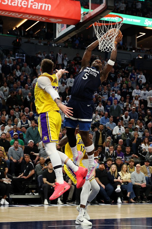 Anthony Edwards #5 of the Minnesota Timberwolves dunks the ball against Luka Doncic #77 of the Los Angeles Lakers in the third quarter of Game Three of the First Round of the 2025 NBA Playoffs at Target Center on April 25, 2025 in Minneapolis, Minnesota. The Timberwolves defeated the Lakers 116-104 to take a 2-1 series lead. NOTE TO USER: User expressly acknowledges and agrees that, by downloading and or using this photograph, User is consenting to the terms and conditions of the Getty Images License Agreement. (Photo by David Berding/Getty Images)