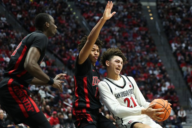 San Diego State guard Miles Byrd drives to the basket against UNLV guard Dedan Thomas Jr. during their game at Viejas Arena on Saturday, Jan. 18, 2025 in San Diego, CA. (Meg McLaughlin / The San Diego Union-Tribune)
