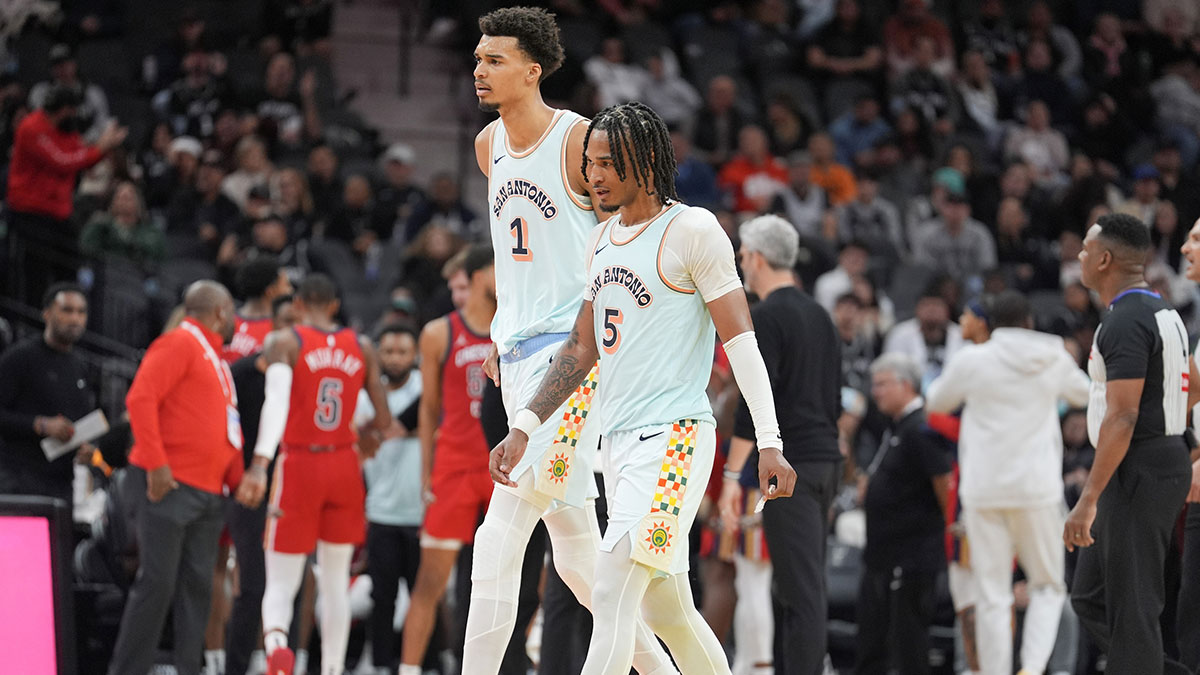 San Antonio Spurs center Victor Wembanyama (1) and guard Stephon Castle (5) walk toward the bench in the second half against the New Orleans Pelicans at Frost Bank Center.