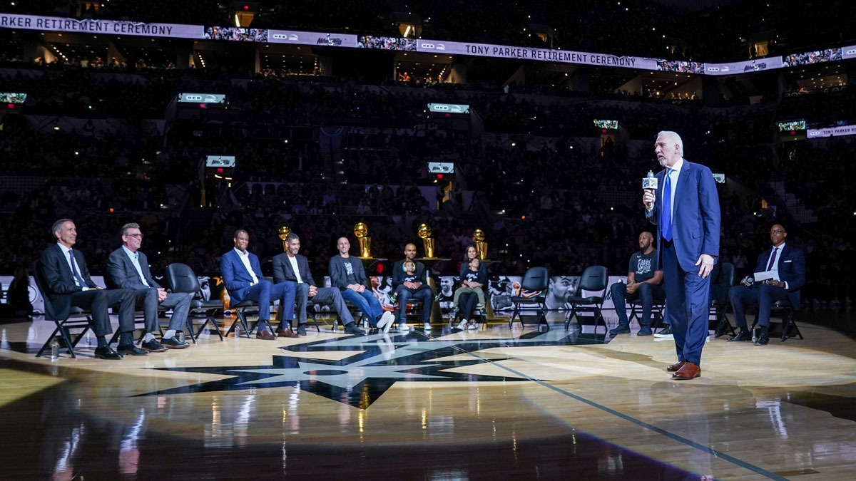 San Antonio Spurs head Gregg Popovich speaks during Tony Parker's retirement ceremony at the AT&T Center. Pictured are Spurs assistant coach Chip Engelland, CEO R.C. Buford, former Spurs players David Robinson, Tim Duncan, Manu Ginobili, Tony Parker, Parker's wife Axelle Francine, Boris Diaw, and Sean Elliott.