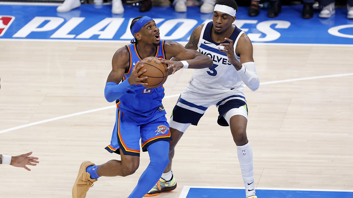 Oklahoma City Thunder guard Shai Gilgeous-Alexander (2) drives against Minnesota Timberwolves forward Jaden McDaniels (3) in the fourth quarter during game two of the western conference finals for the 2025 NBA Playoffs at Paycom Center.
