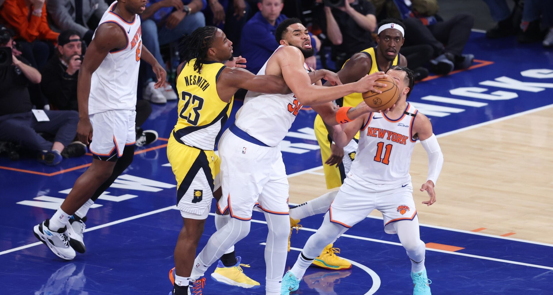 New York Knicks center Karl-Anthony Towns (32) and Indiana Pacers forward Aaron Nesmith (23) fight for the rebound in the third quarter during game two of the eastern conference finals for the 2025 NBA Playoffs at Madison Square Garden.