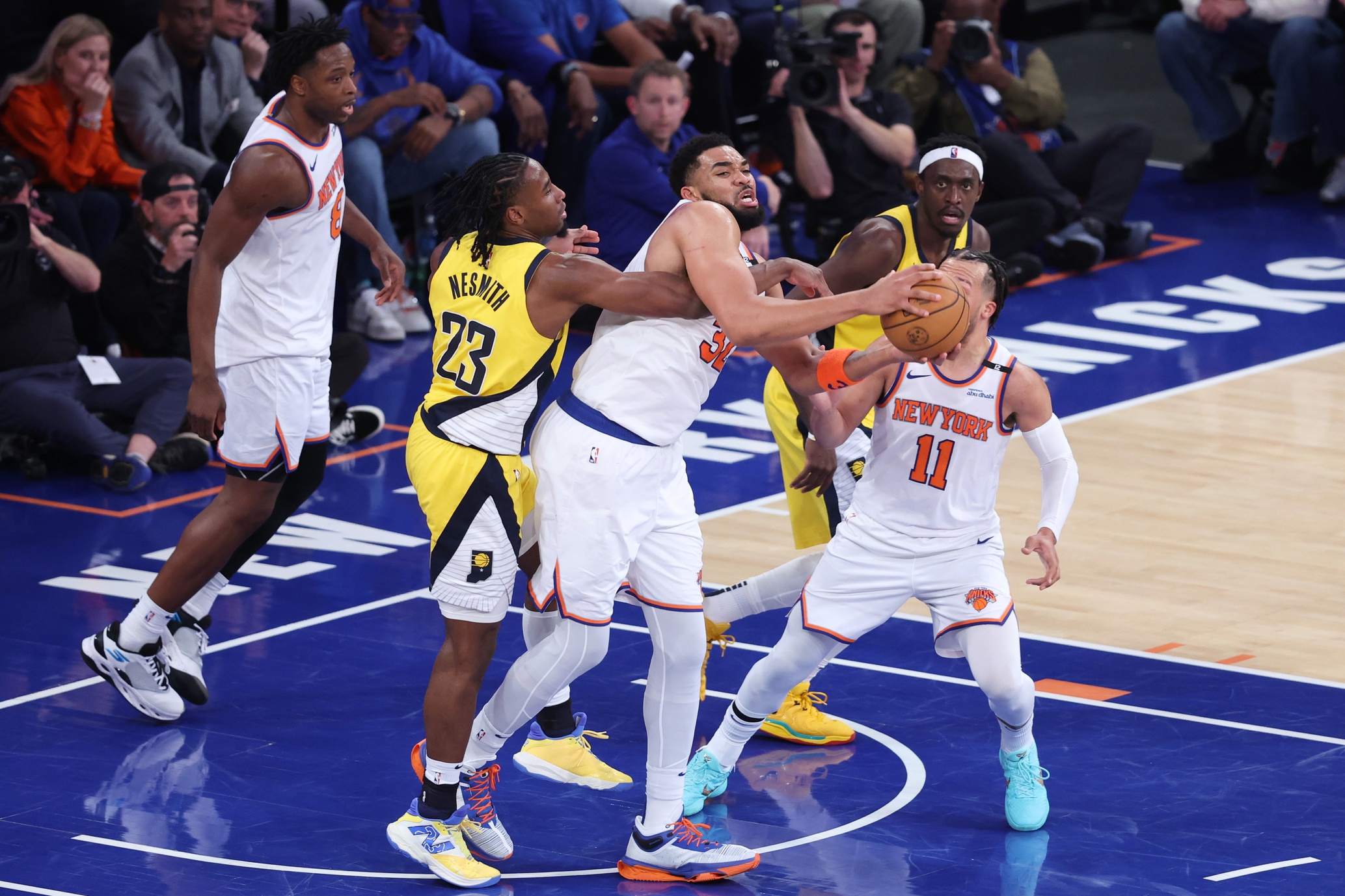 New York Knicks center Karl-Anthony Towns (32) and Indiana Pacers forward Aaron Nesmith (23) fight for the rebound in the third quarter during game two of the eastern conference finals for the 2025 NBA Playoffs at Madison Square Garden.