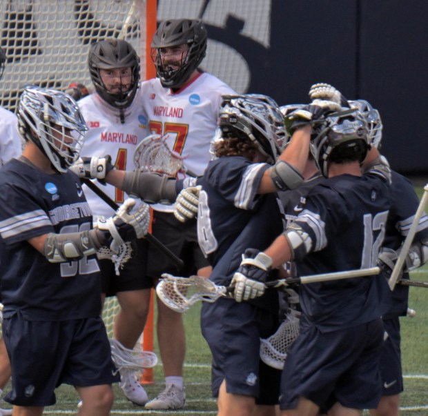 Maryland Terrapins defender Will Schaller, right encourages goalkeeper Logan McNaney...