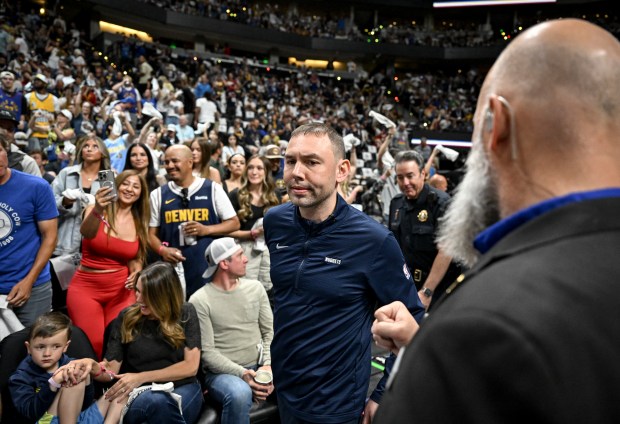 Head coach David Adelman of the Denver Nuggets takes the...