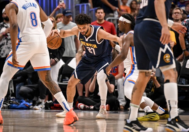 Jamal Murray (27) of the Denver Nuggets backs down Luguentz...