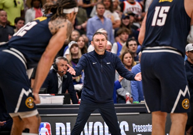 Head coach David Adelman of the Denver Nuggets disputes a...