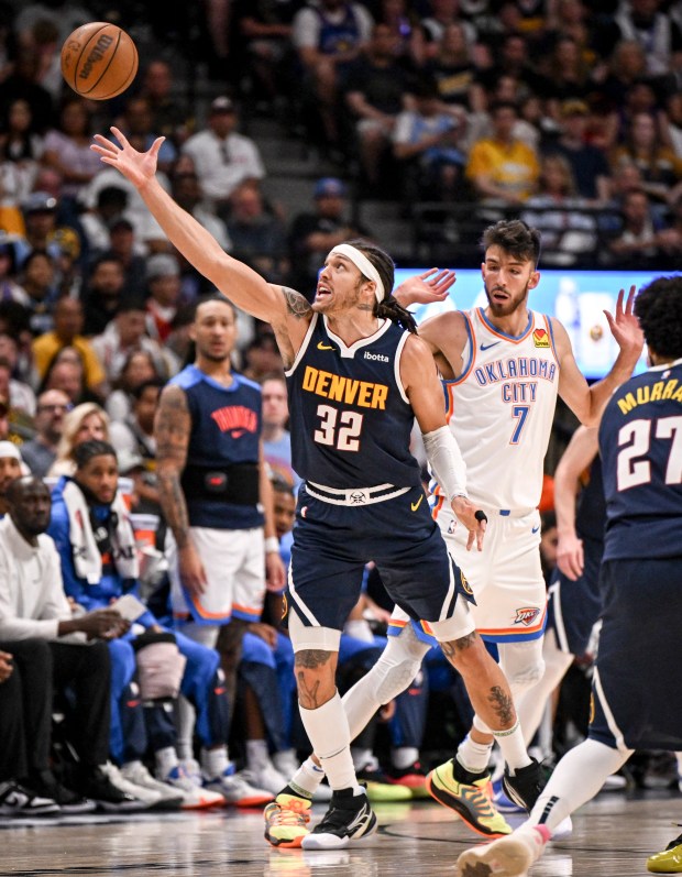Aaron Gordon (32) of the Denver Nuggets wrangles a pass...
