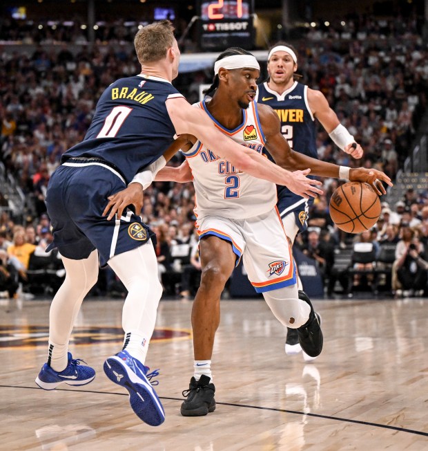 Christian Braun (0) of the Denver Nuggets pokes the ball...