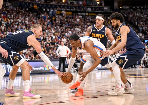 Nikola Jokic (15) of the Denver Nuggets pokes the ball...