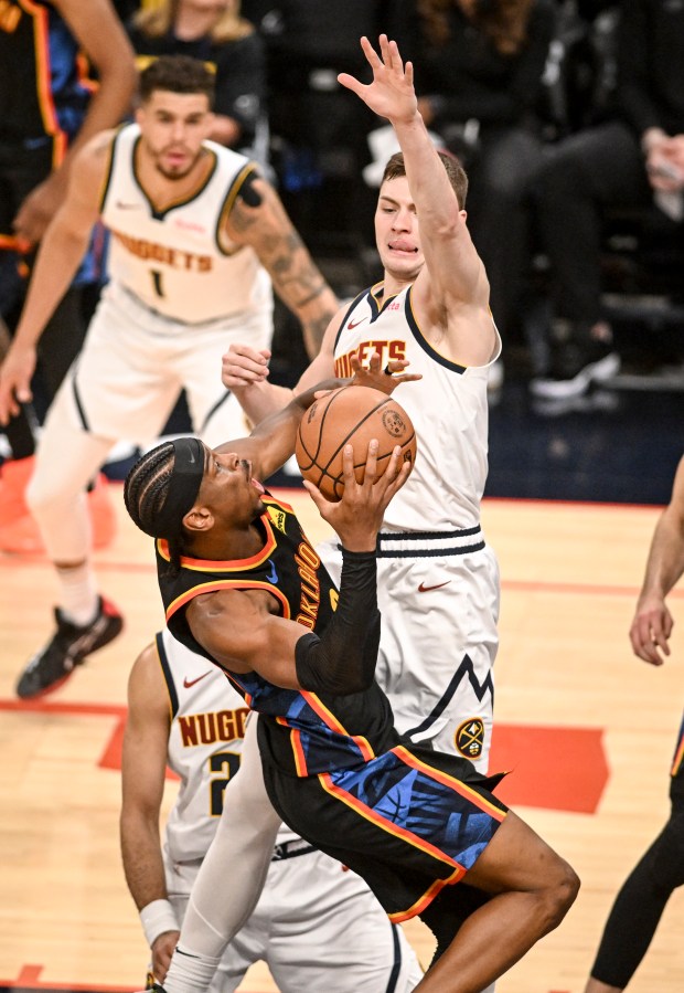 Christian Braun (0) of the Denver Nuggets defends Shai Gilgeous-Alexander...