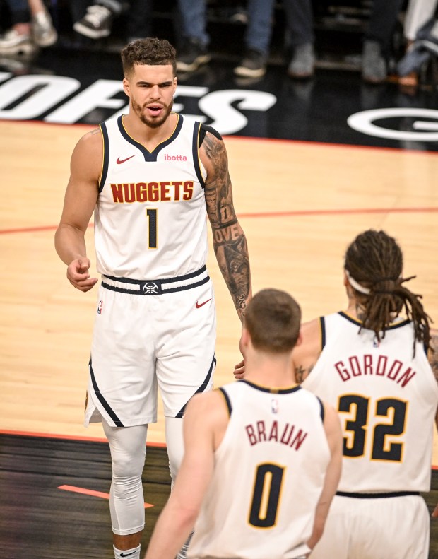 Michael Porter Jr. (1) talks to Aaron Gordon (32) and...