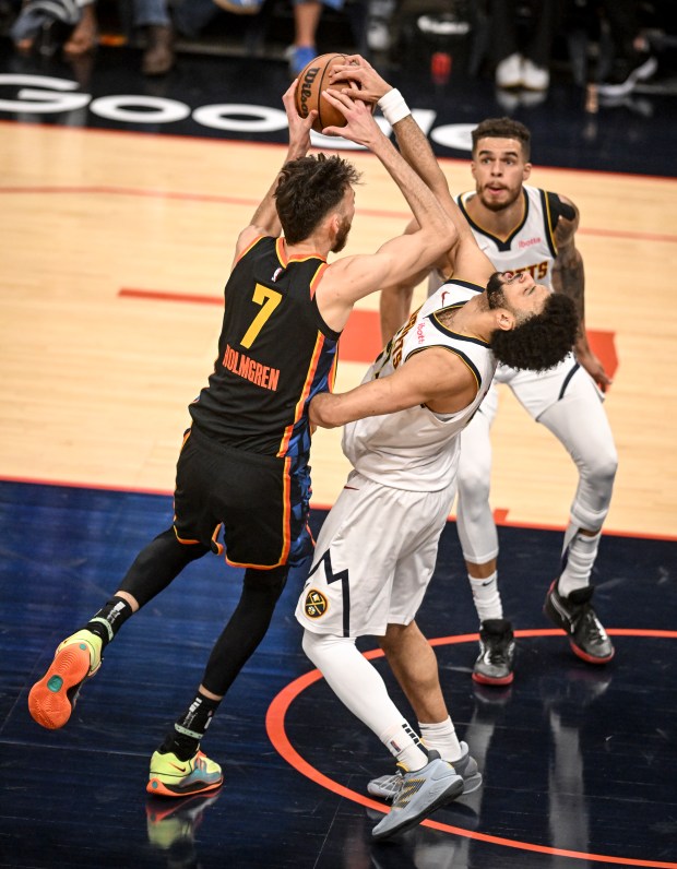 Jamal Murray (27) of the Denver Nuggets defends Chet Holmgren...