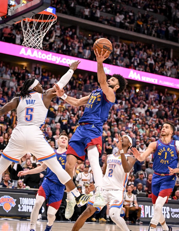 Jamal Murray (27) of the Denver Nuggets scores over Luguentz...