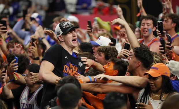 Florida forward Alex Condon celebrates with fans after winning the NCAA Basketball National Championship Game of Florida vs. Houston at the Alamodome in San Antonio on Monday, April 7, 2025. Florida won the game 65-63. (Stephen M. Dowell/Orlando Sentinel)