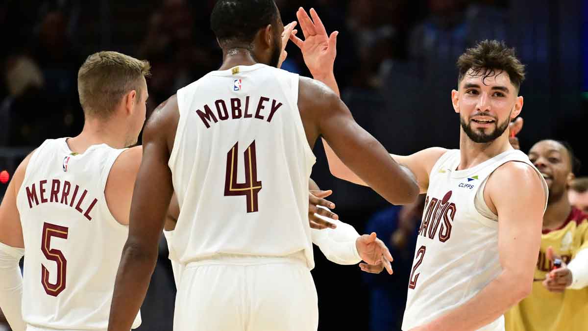 Cleveland Cavaliers guard Ty Jerome (2) celebrates after hitting a three point basket with guard Sam Merrill (5) and forward Evan Mobley (4) during the second half against the Toronto Raptors at Rocket Mortgage FieldHouse.