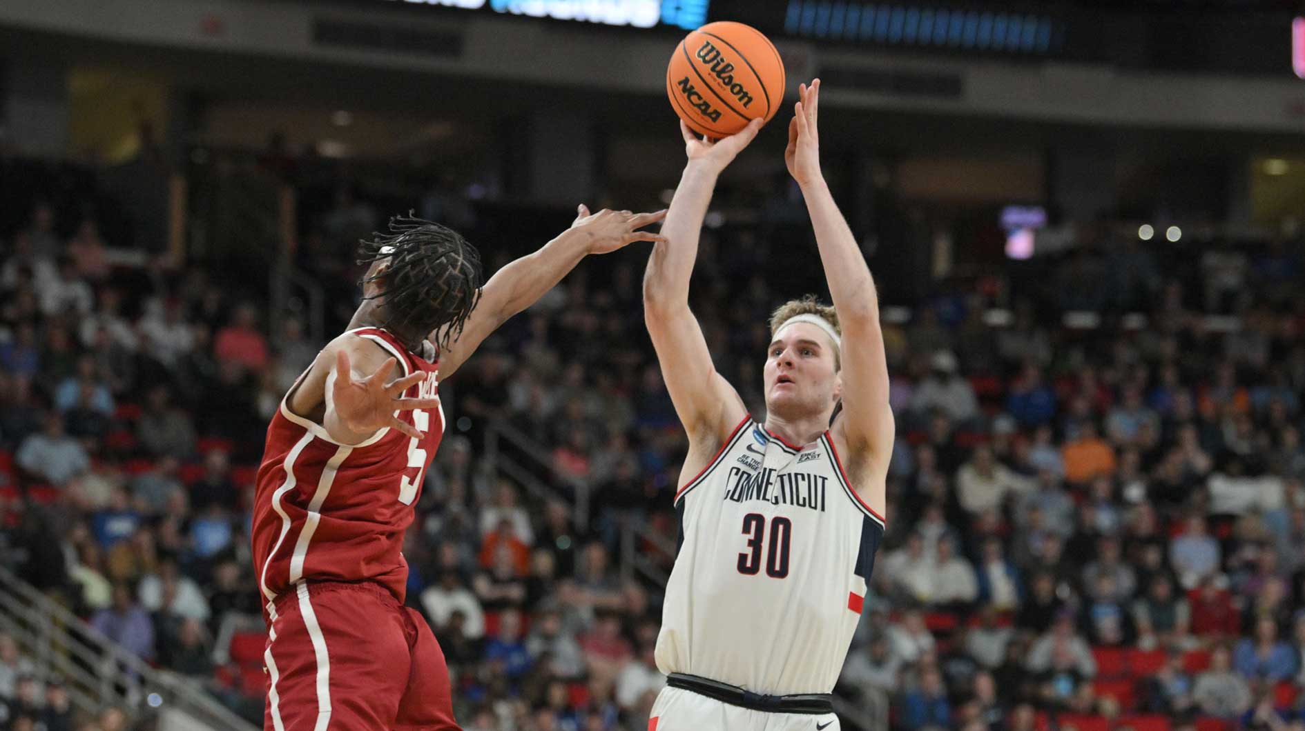 Oklahoma Sooners forward Mohamed Wague (5) defends against Connecticut Huskies forward Liam McNeeley (30) during the first half at Lenovo Center.