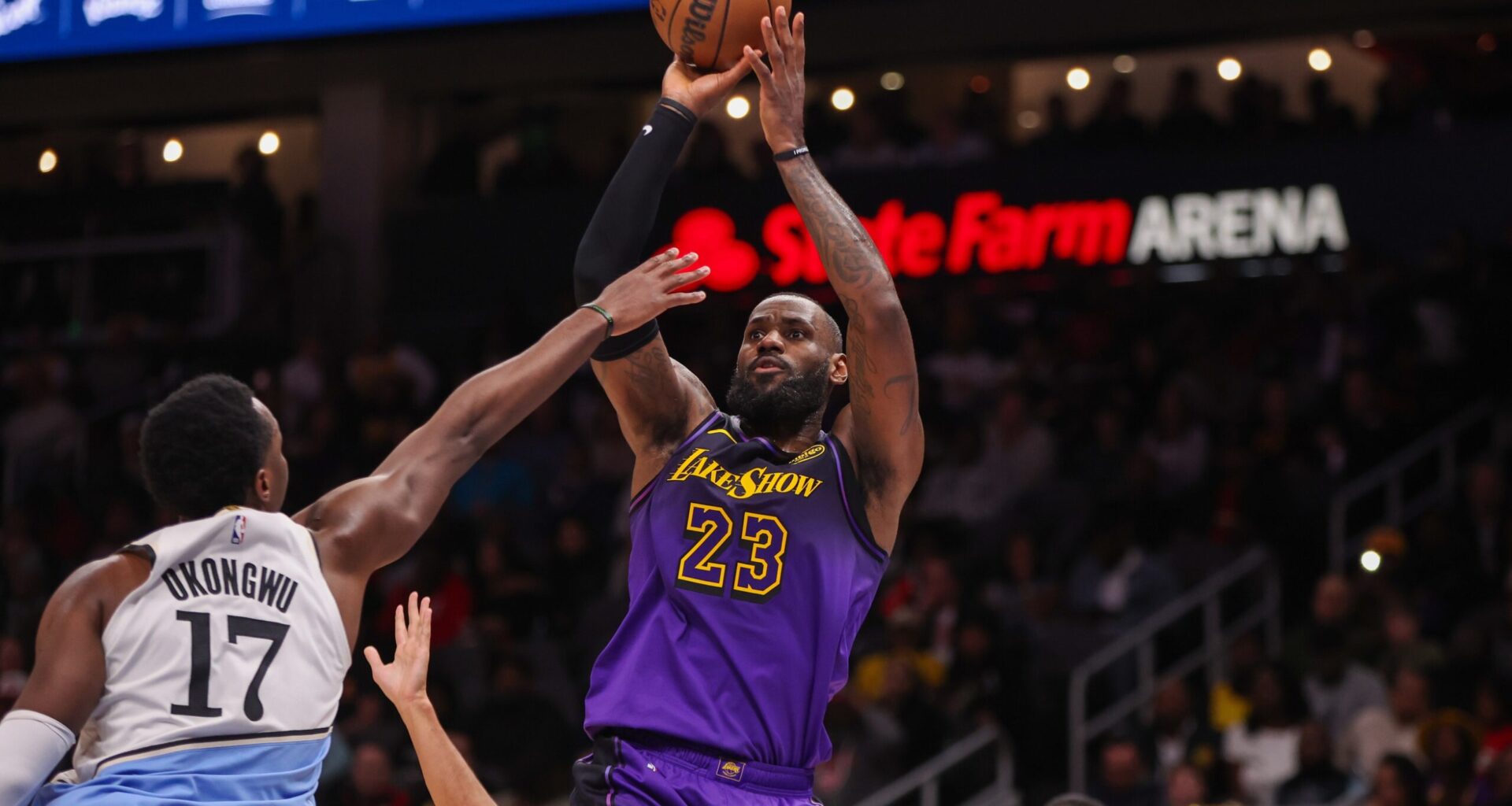 Dec 6, 2024; Atlanta, Georgia, USA; Los Angeles Lakers forward LeBron James (23) shoots over Atlanta Hawks forward Onyeka Okongwu (17) in the second quarter at State Farm Arena. Mandatory Credit: Brett Davis-Imagn Images
