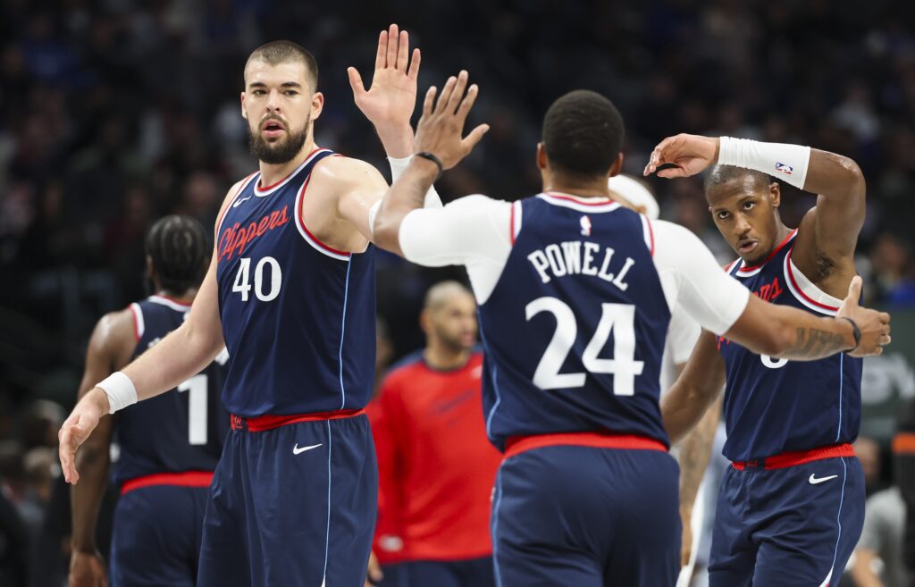 LA Clippers center Ivica Zubac (40) celebrates with LA Clippers guard Norman Powell (24) and LA Clippers guard Kris Dunn (8) 