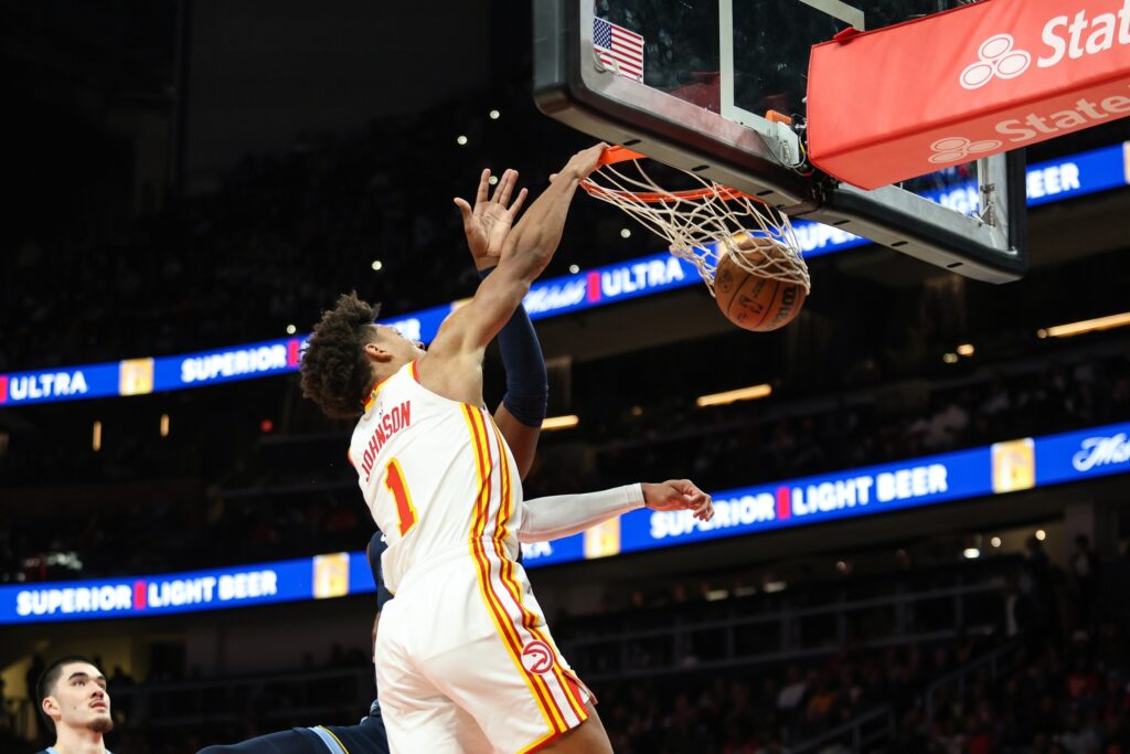 Dec 21, 2024; Atlanta, Georgia, USA; Atlanta Hawks forward Jalen Johnson (1) dunks the ball against the Memphis Grizzlies during the first half at State Farm Arena. Mandatory Credit: Jordan Godfree-Imagn Images