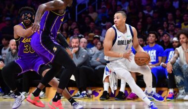 Feb 25, 2025; Los Angeles, California, USA; Dallas Mavericks guard Dante Exum (0) dribbles the ball against Los Angeles Lakers forward Dorian Finney-Smith (17) during the first half at Crypto.com Arena. Mandatory Credit: Gary A. Vasquez-Imagn Images