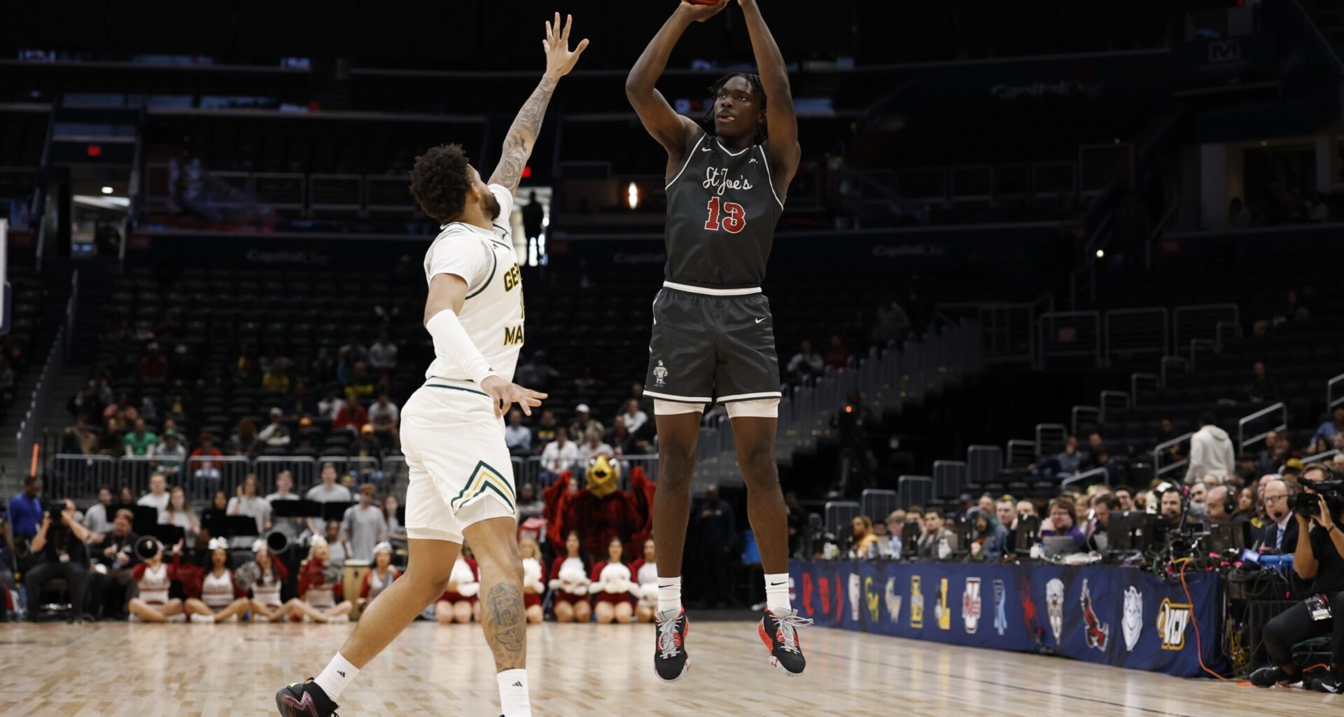 Saint Joseph's Hawks forward Rasheer Fleming (13) shoots the ball over Saint Joseph's Hawks forward Shawn Simmons II (10) in the first half at Capital One Arena.