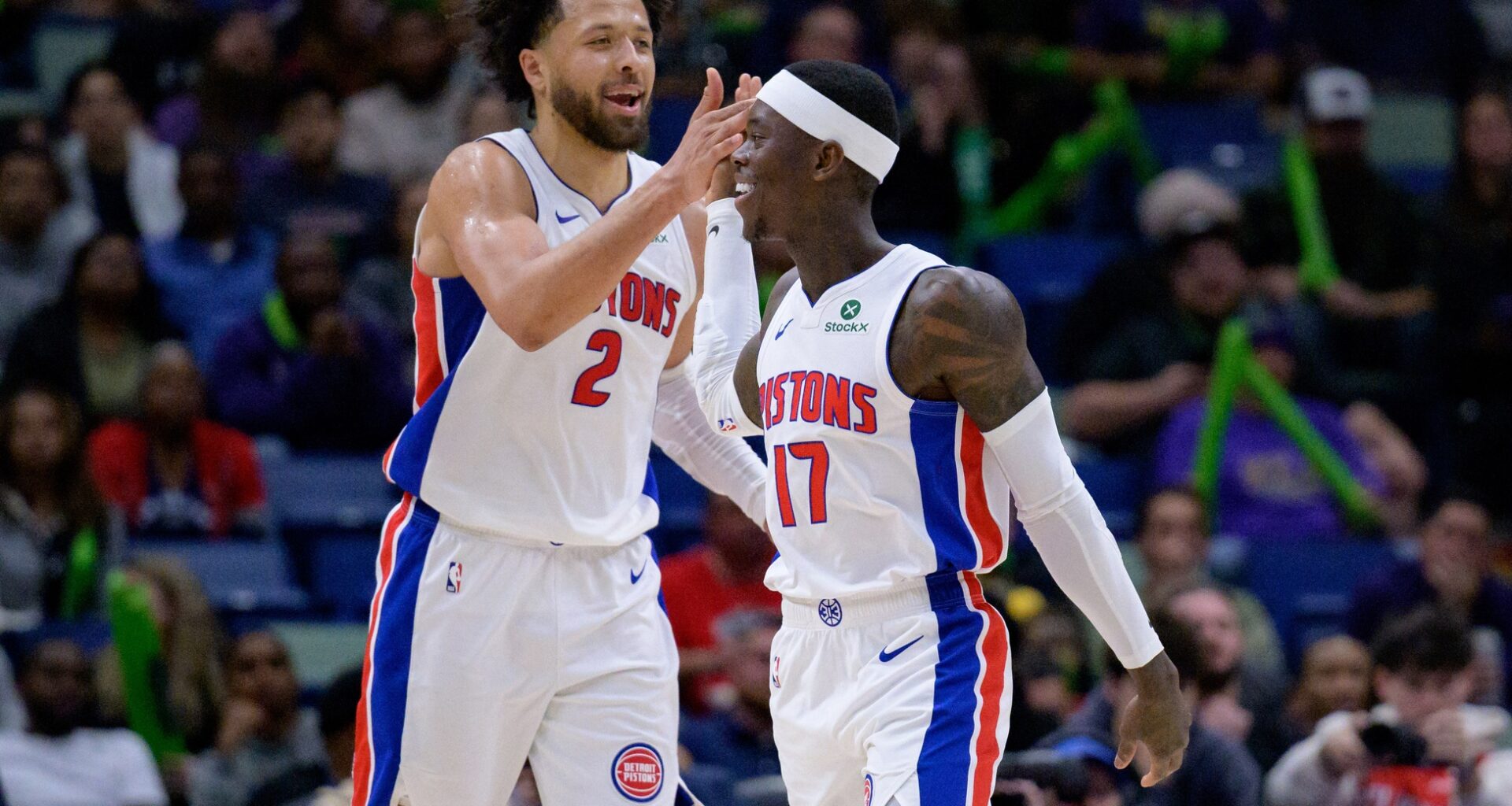 Detroit Pistons guard Cade Cunningham (2) celebrates a basket with guard Dennis Schroder (17) against the New Orleans Pelicans during the second half at Smoothie King Center.
