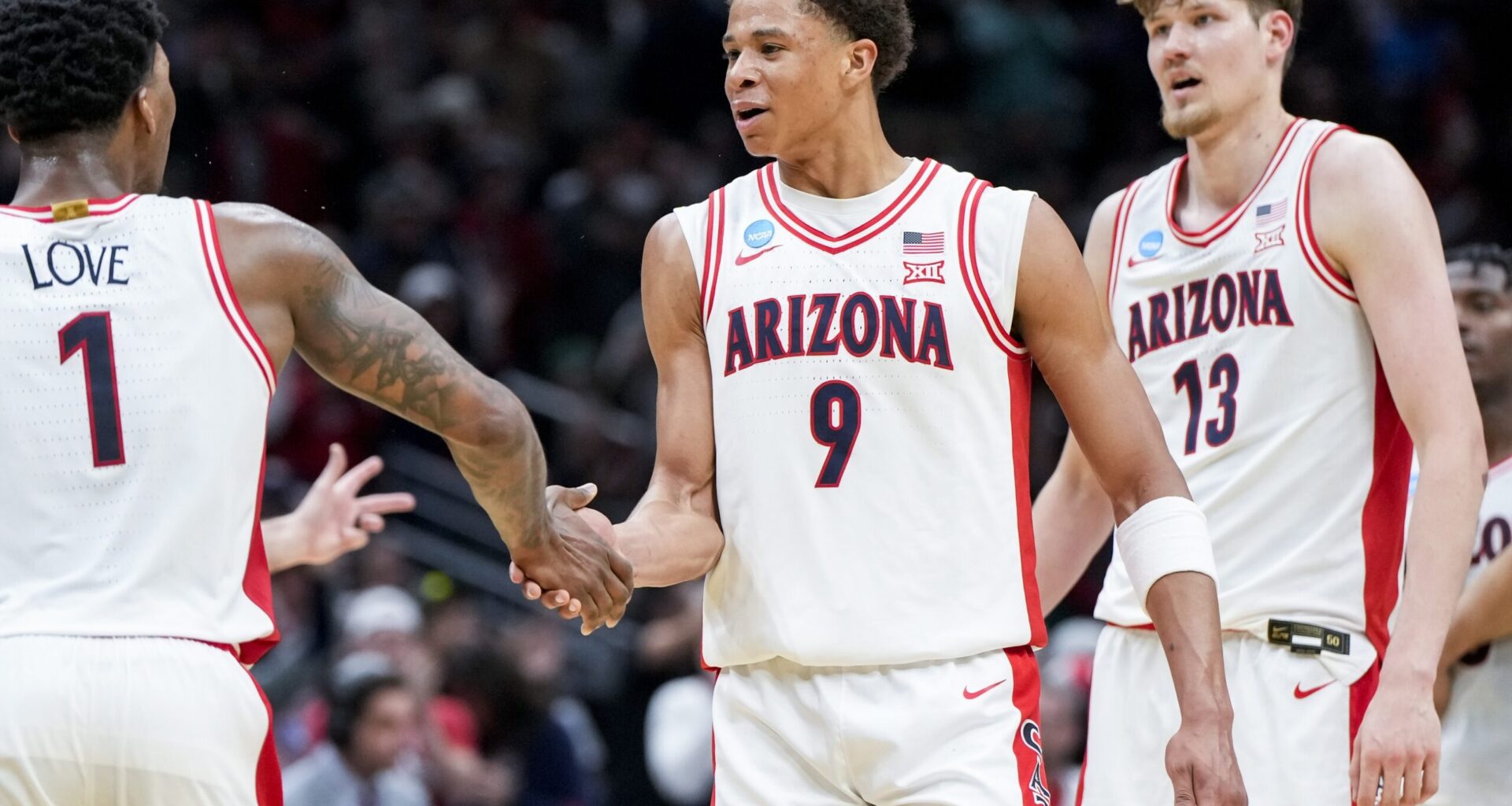 Mar 23, 2025; Seattle, WA, USA; Arizona Wildcats guard Caleb Love (1) high-fives forward Carter Bryant (9) during a stop in play against the Oregon Ducks in the second half at Climate Pledge Arena. Mandatory Credit: Stephen Brashear-Imagn Images