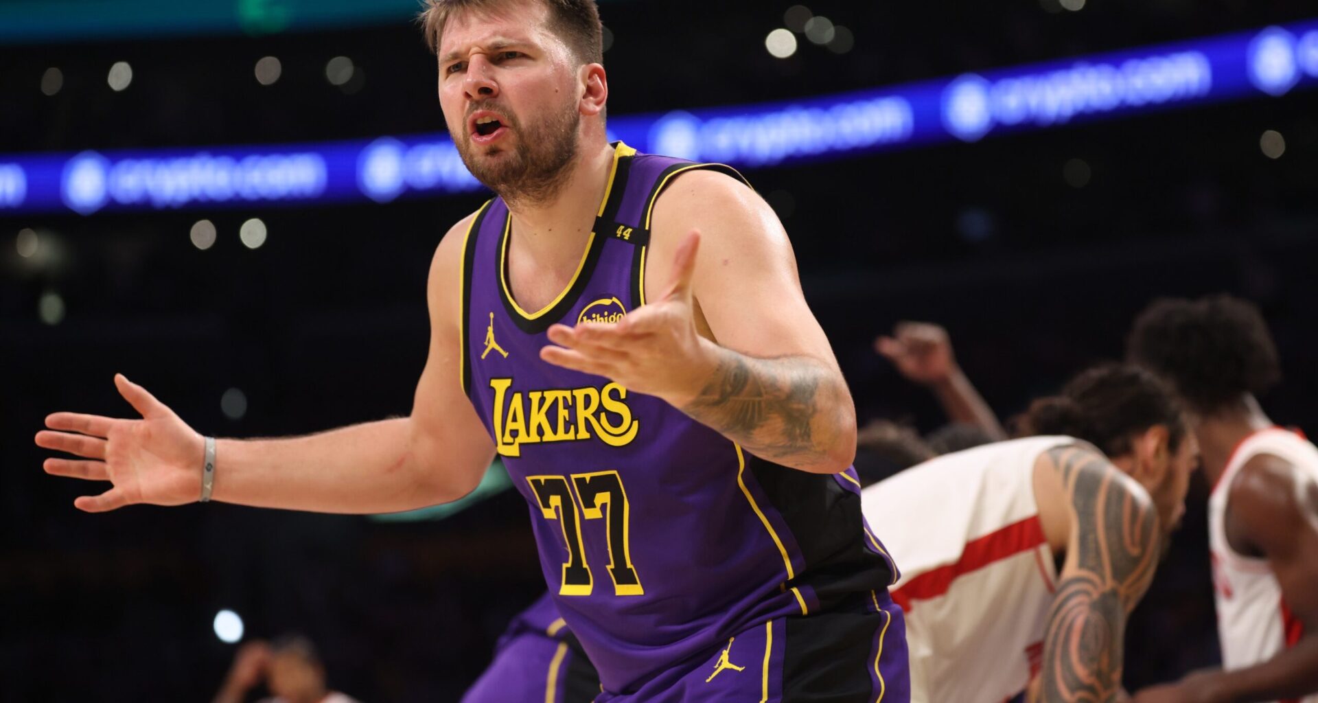 Mar 31, 2025; Los Angeles, California, USA; Los Angeles Lakers guard Luka Doncic (77) reacts to a play during the third quarter against the Houston Rockets at Crypto.com Arena. Mandatory Credit: Kiyoshi Mio-Imagn Images